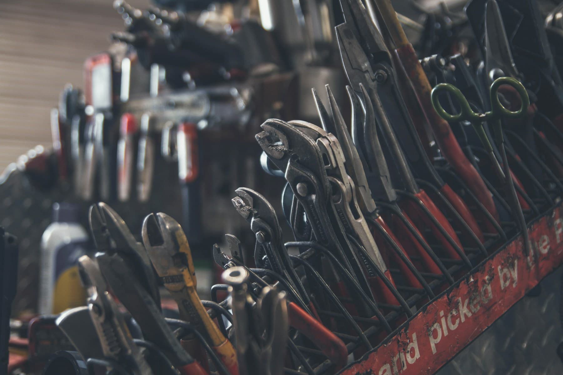 Workshop tools arranged on a workbench; illustrative editorial photography
